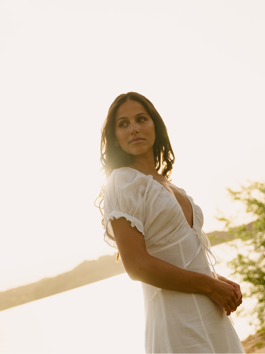 Mujer junto al agua al atardecer